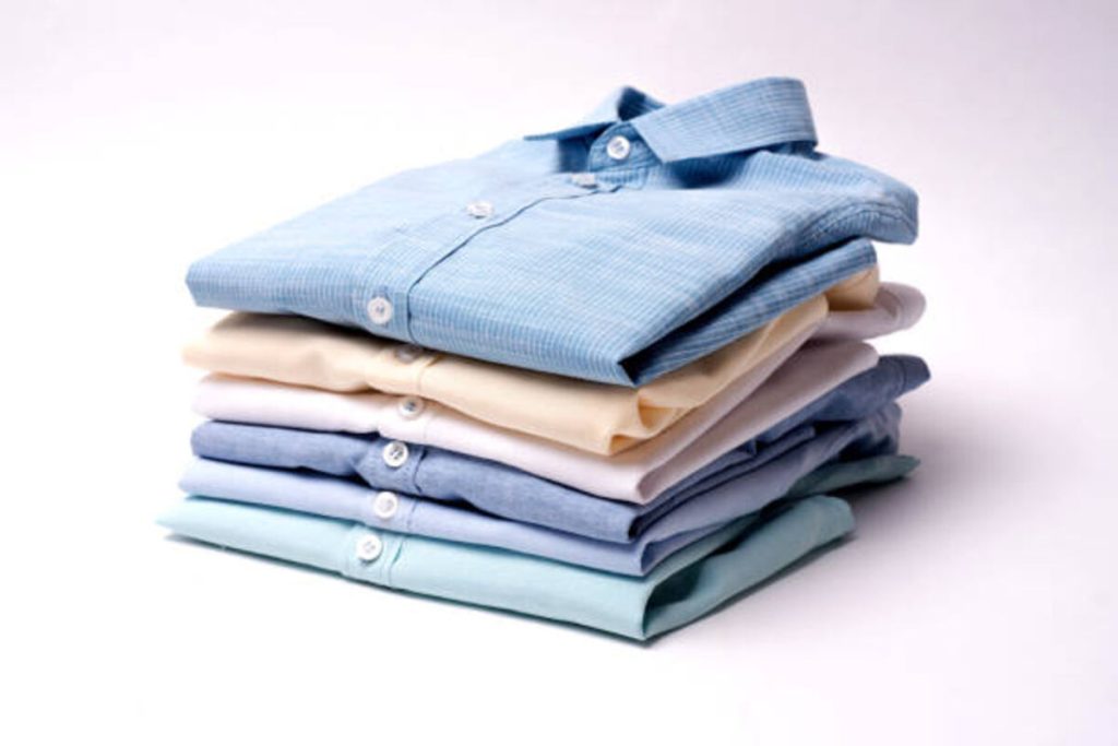 classic mens shirts stacked on white background